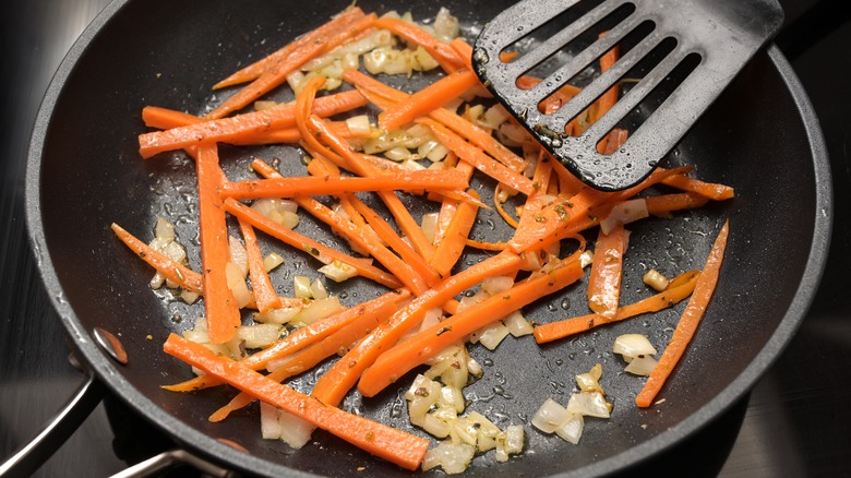 Julienne carrots in frying pan