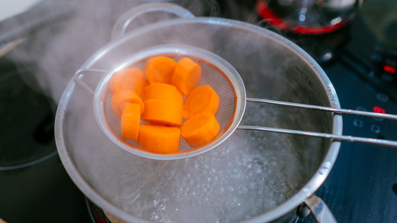 Chopped carrots over boiling water 