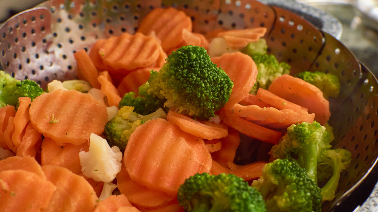 Veggies in metal steamer basket