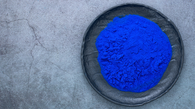blue spirulina powder on plate