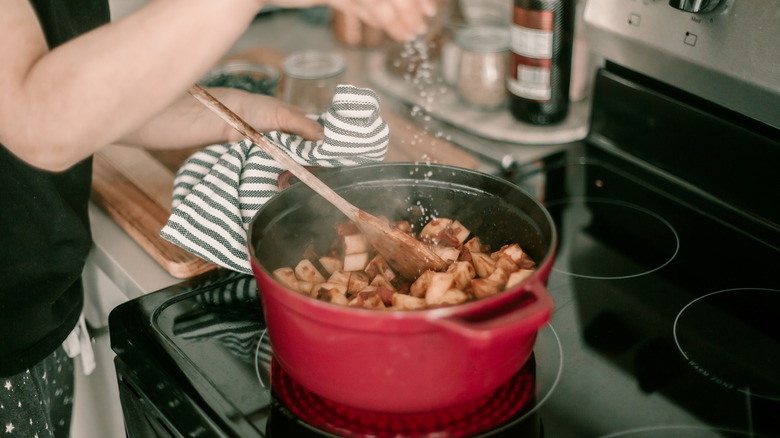 Chef gripping pot with towel