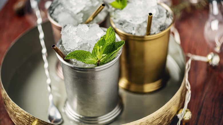 Mint juleps in silver, gold, and copper cups