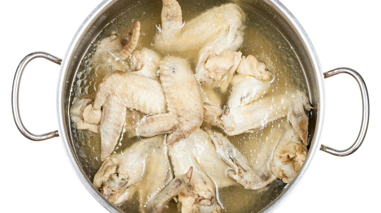 boiling chicken wings in pot