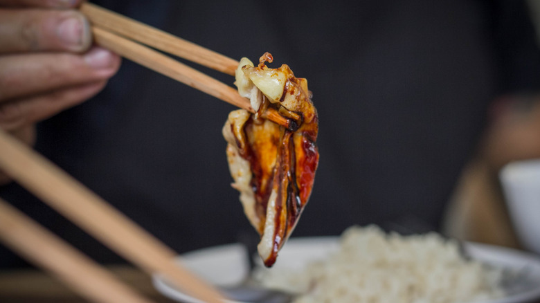 steamed chicken wing in chopsticks