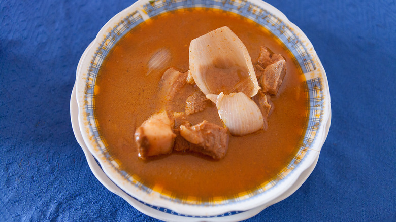 bowl of Peruvian adobo on a blue tablecloth