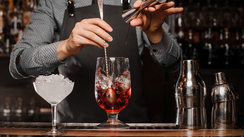 Cocktail being stirred in mixing glass