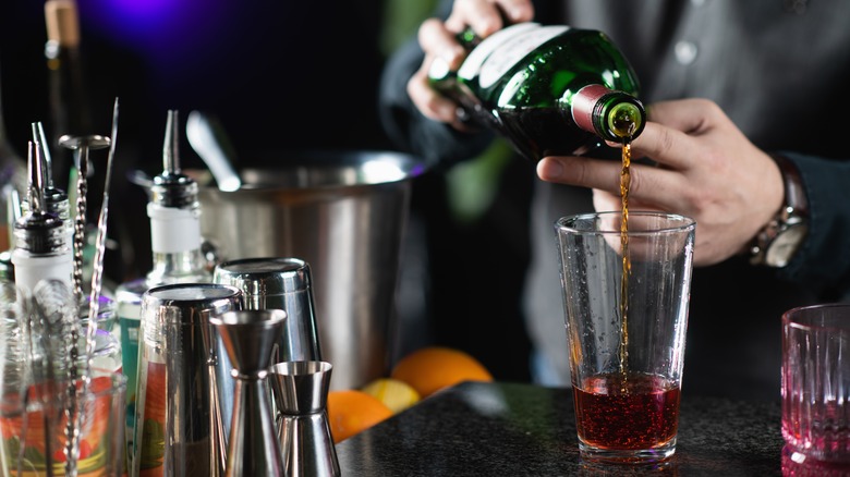 Bottle of vermouth being poured into glass