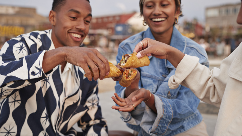 friends cheersing tacos