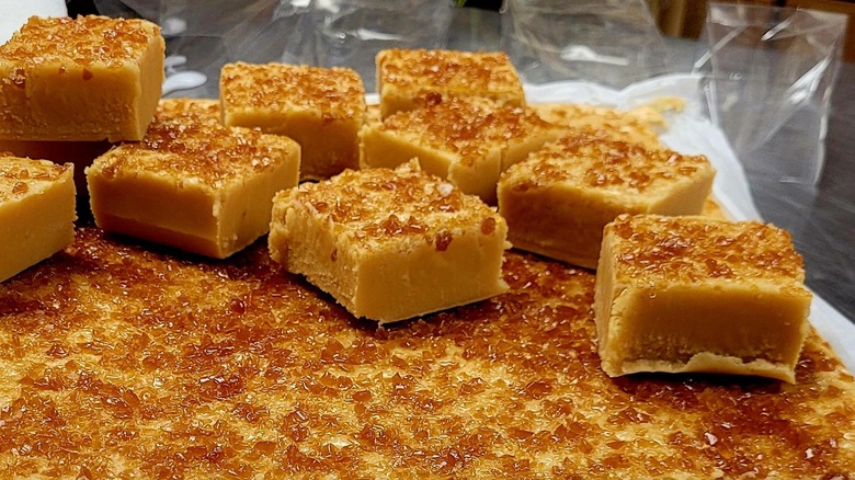 A slab of creme brulee fudge is cut into pieces