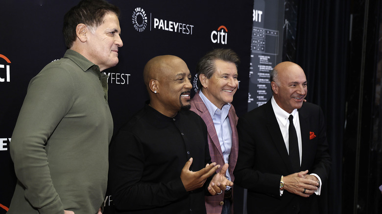 Mark Cuban, Daymond John, Robert Herjavec, and Kevin O'Leary posing at an event