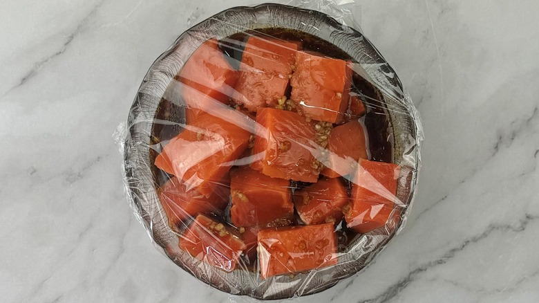 marinating salmon covered with plastic