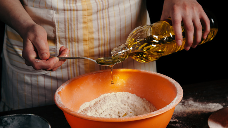 Pouring oil into a spoon