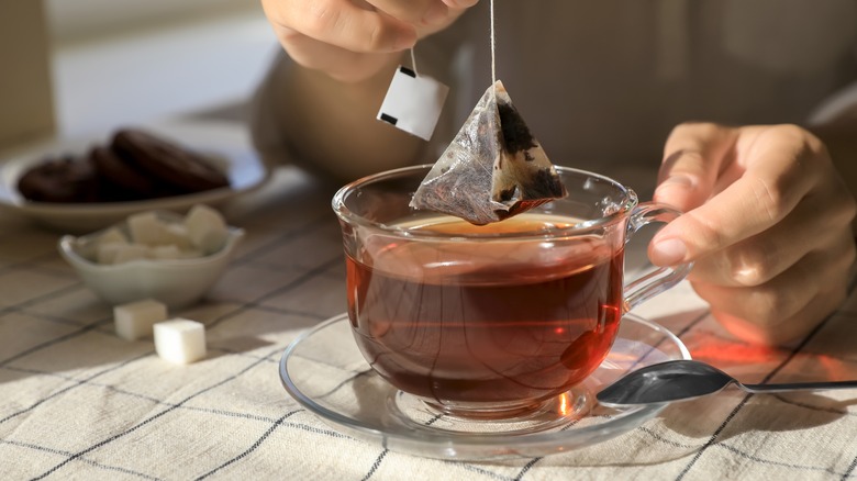 Removing tea bag from tea