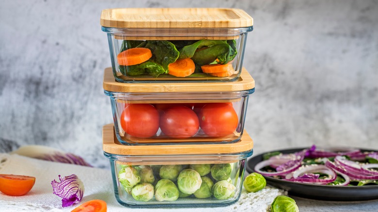 food stored in glass boxes with wooden lids