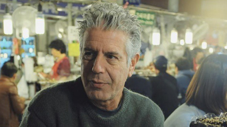 Anthony Bourdain eating at a street stall