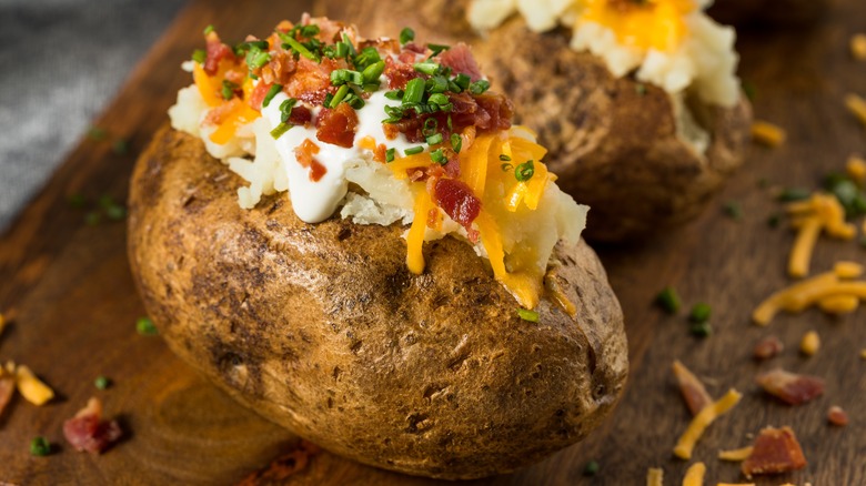 Close up of baked potato with sour cream and bacon