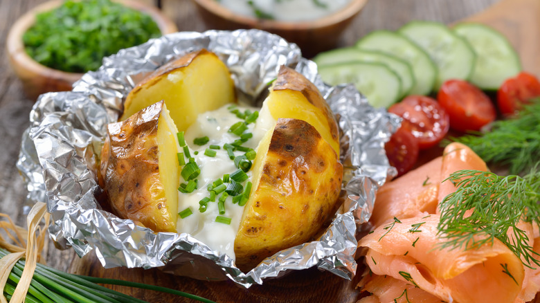 Baked potato with sour cream and green onions