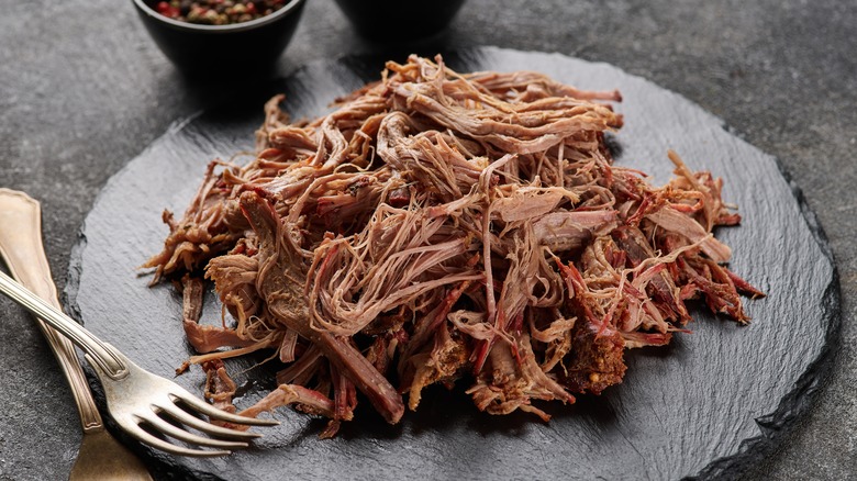 Barbecue pulled pork on a black slate