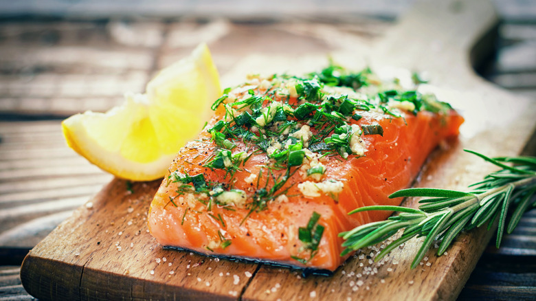 Salmon covered with fresh sliced herbs