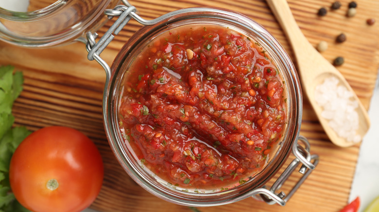 An open jar of salsa on a table