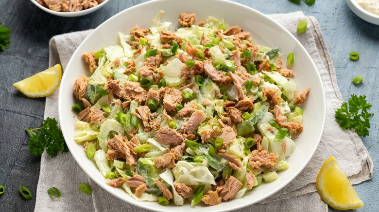 bowl of tuna salad with vegetables and herbs