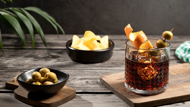 Vermouth with olives and orange rind and chips