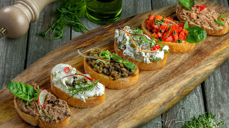 Crostini with different toppings including canned tuna salad