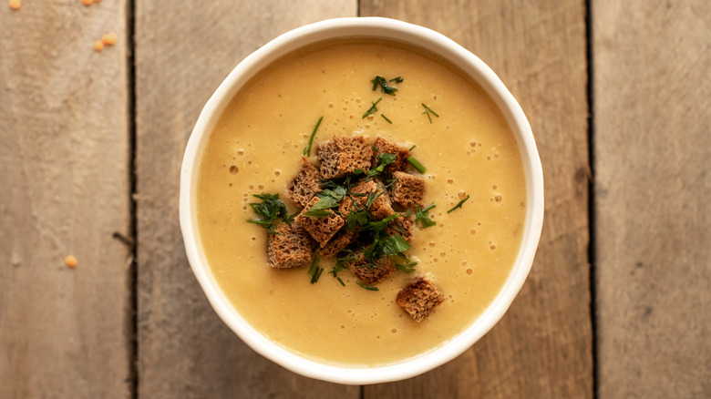 Creamy soup topped with croutons and herbs