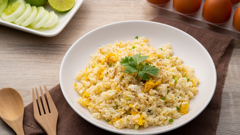 Egg fried rice with leaf sprigs in bowl