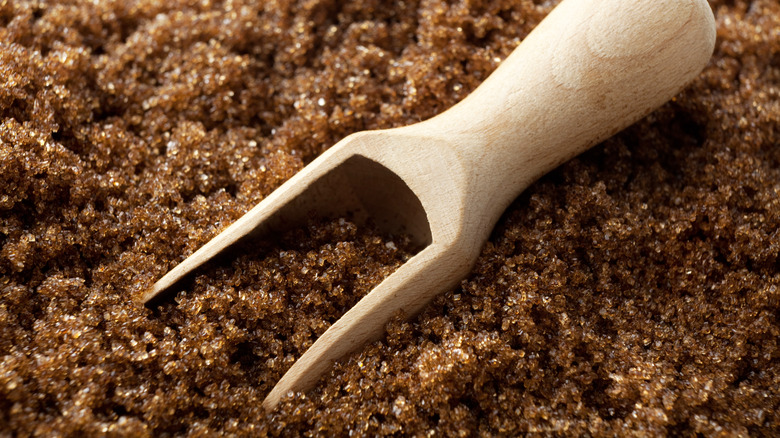 Brown sugar with a wooden spoon