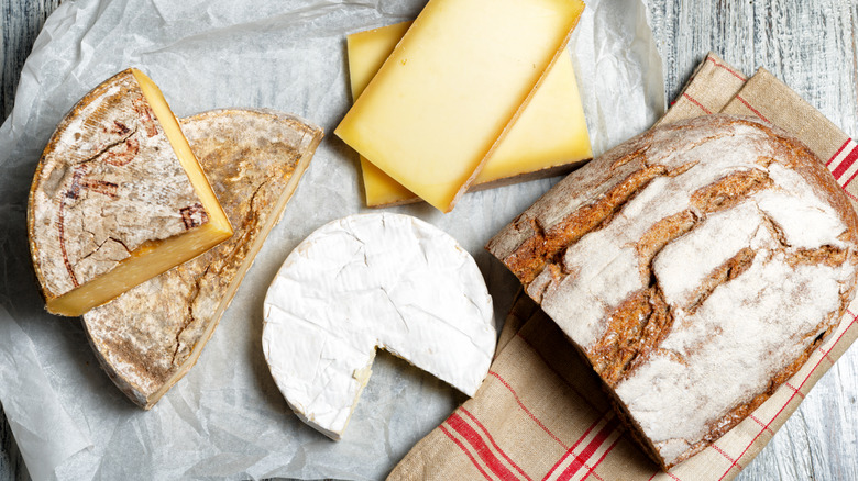 French cheeses and half loaf of bread