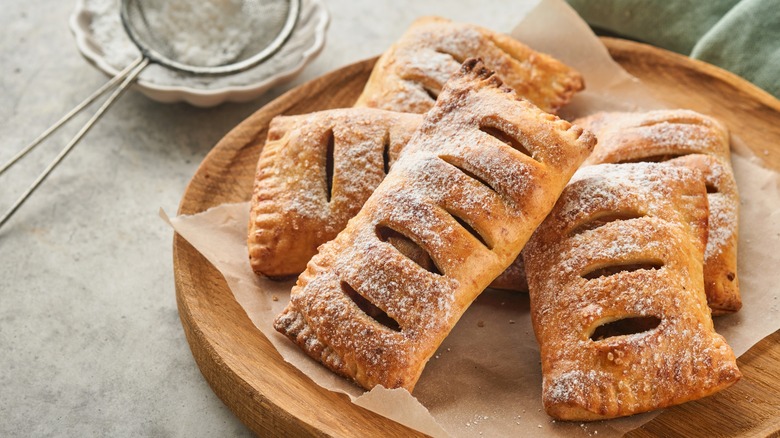 Hand pies with powdered sugar on plate