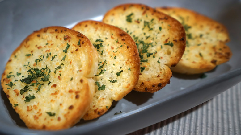 slices of buttery garlic bread on grey plate