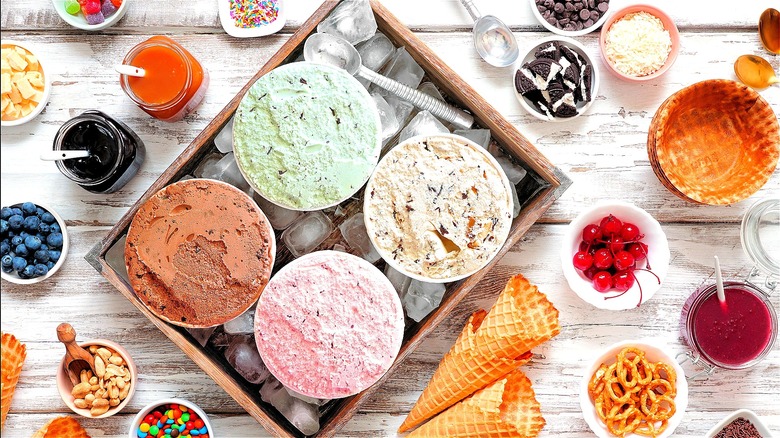 Assorted ice cream flavors and toppings on a table