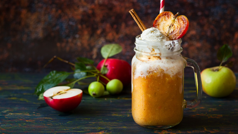 apple cider float with cinnamon stick and apple