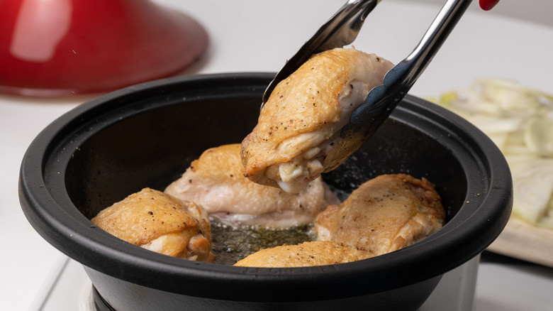 Browning chicken in a pan 