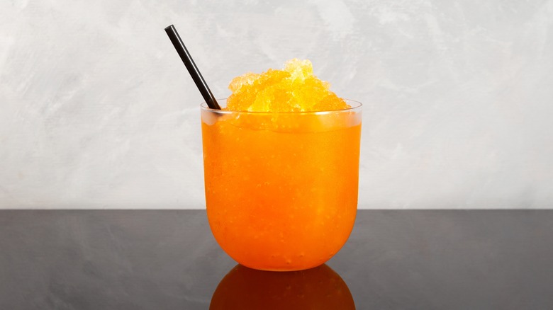 Orange granita in glass with straw