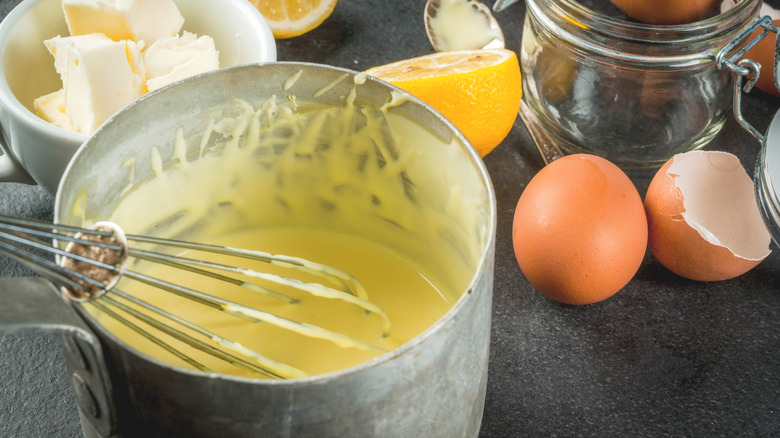 Hollandaise sauce in pan with ingredients