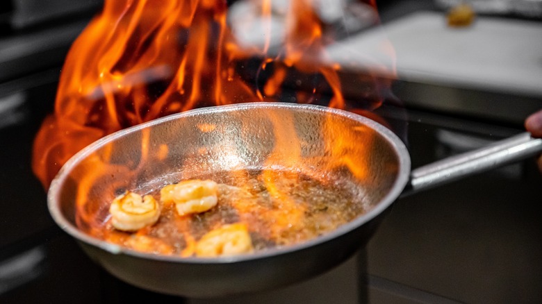 Seafood flambéing in a pan