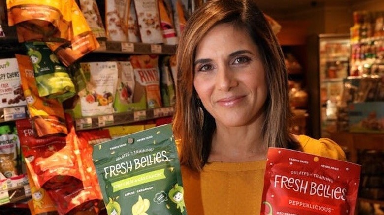 Saskia Sorrosa holding packs of Fresh Bellies snacks 
