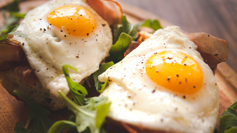 fried eggs and greens on sandwiches