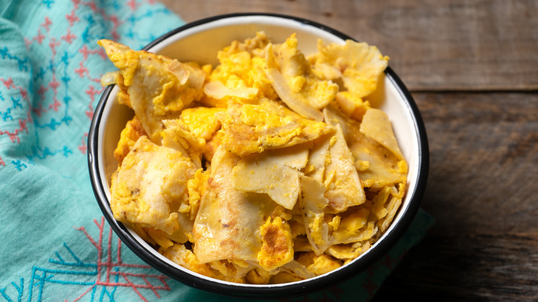 Bowl of migas on a wooden table