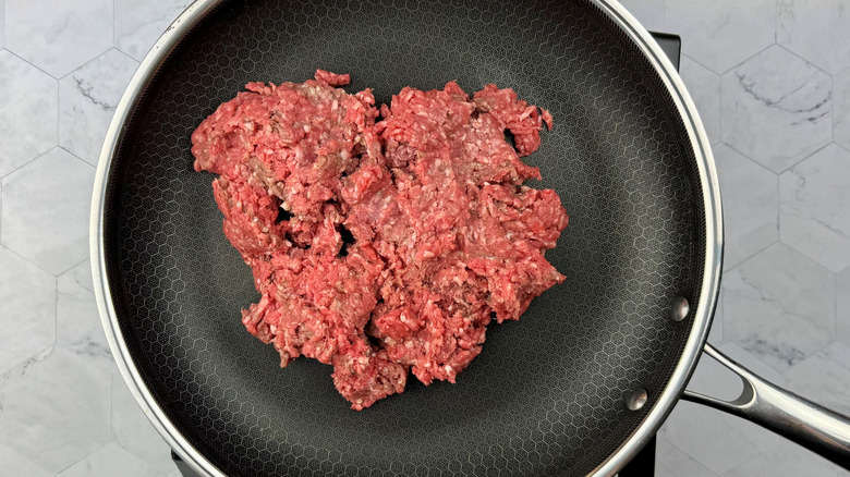 Raw ground beef in skillet