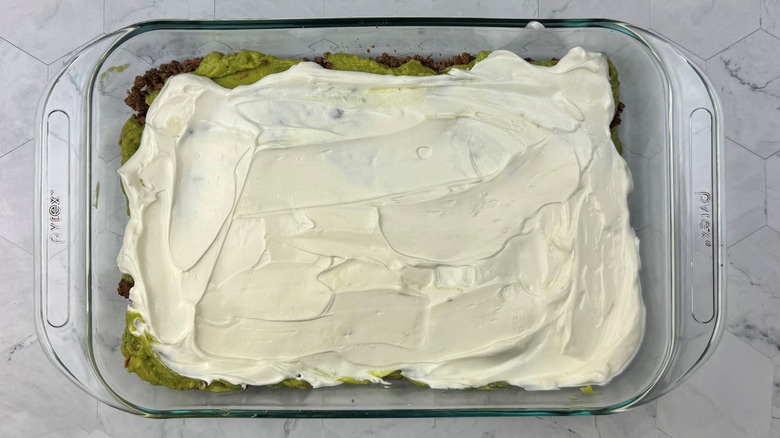 Sour cream spread out in large dish