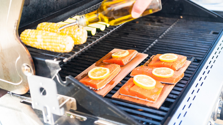 Grilling salmon and corn on gas grill