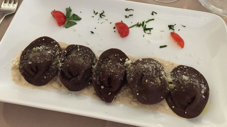 chocolate ravioli with gorgonzola sauce on plate