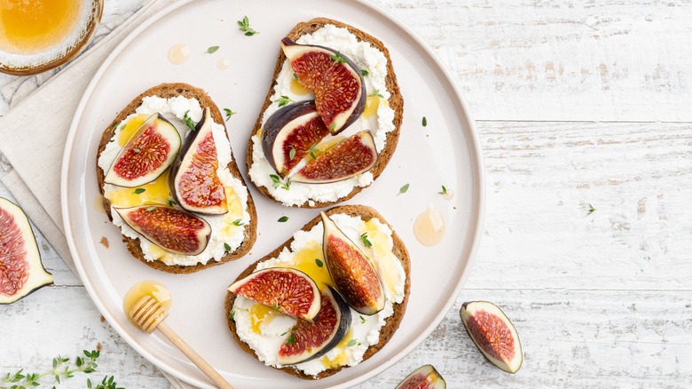Bruschetta topped with cheese, figs, and honey
