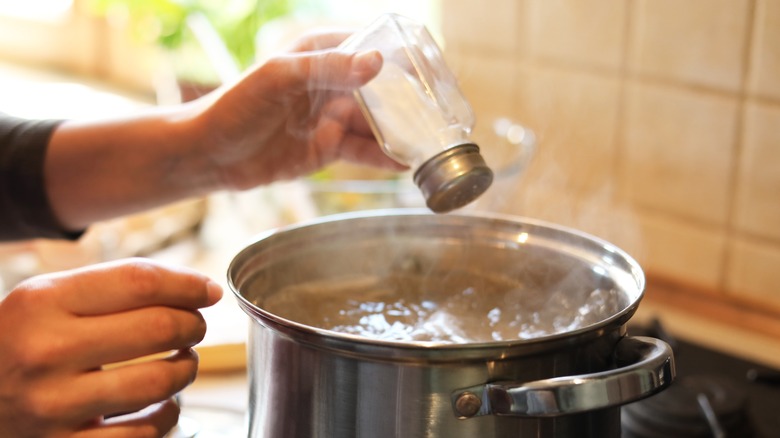adding salt to boiling water