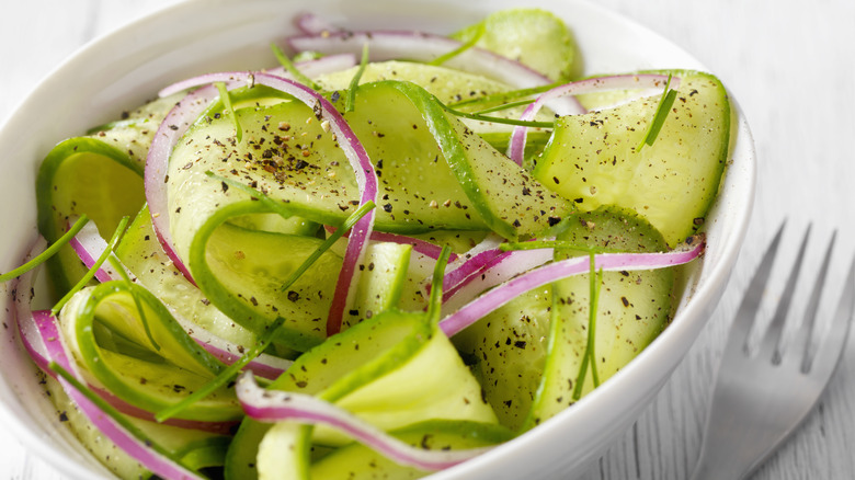 Cucumber salad with red onion in a bowl