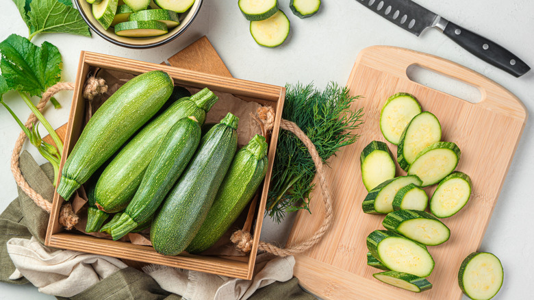 sliced zucchini and whole zucchinis